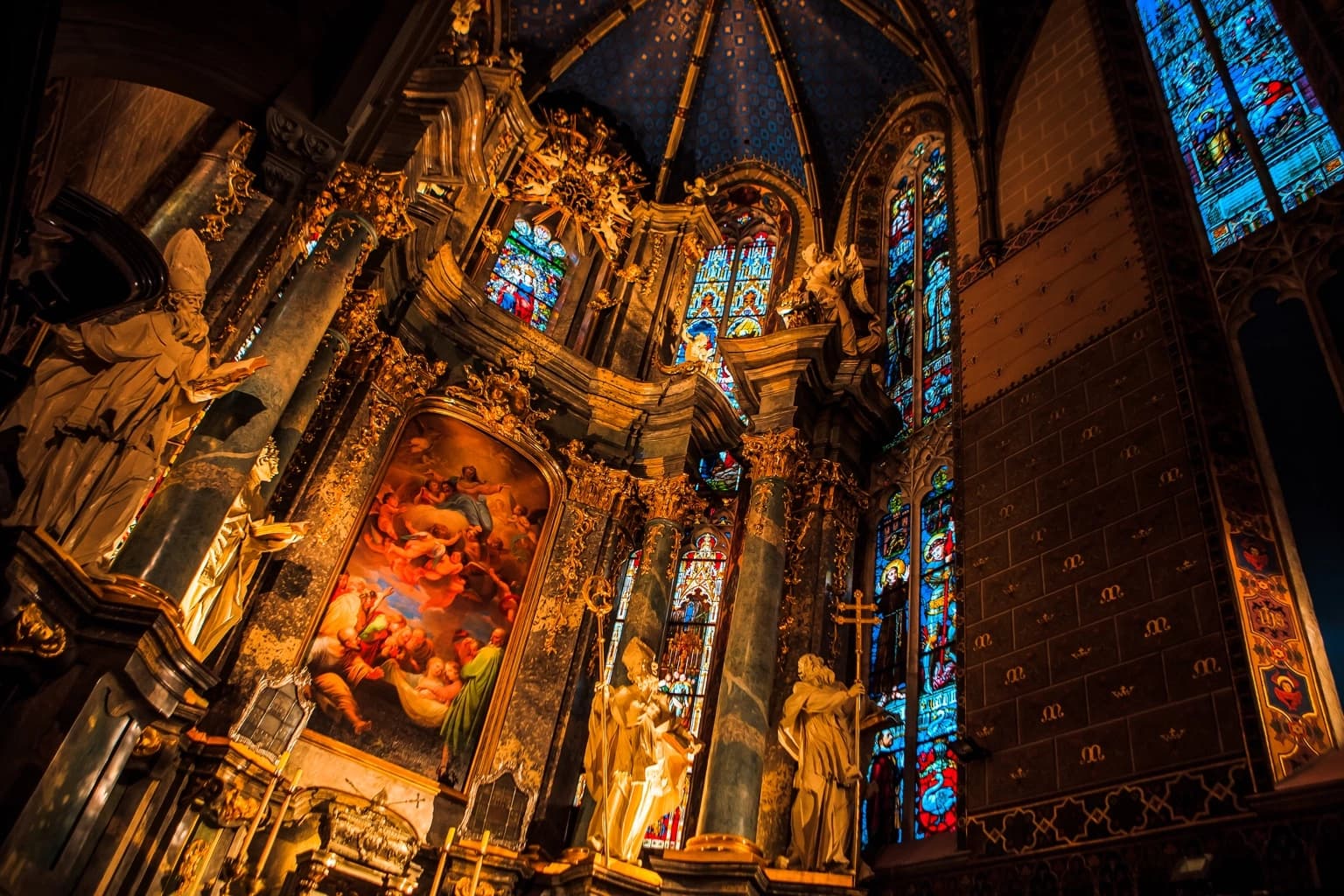 Gilded altar, statues, and stained-glass windows