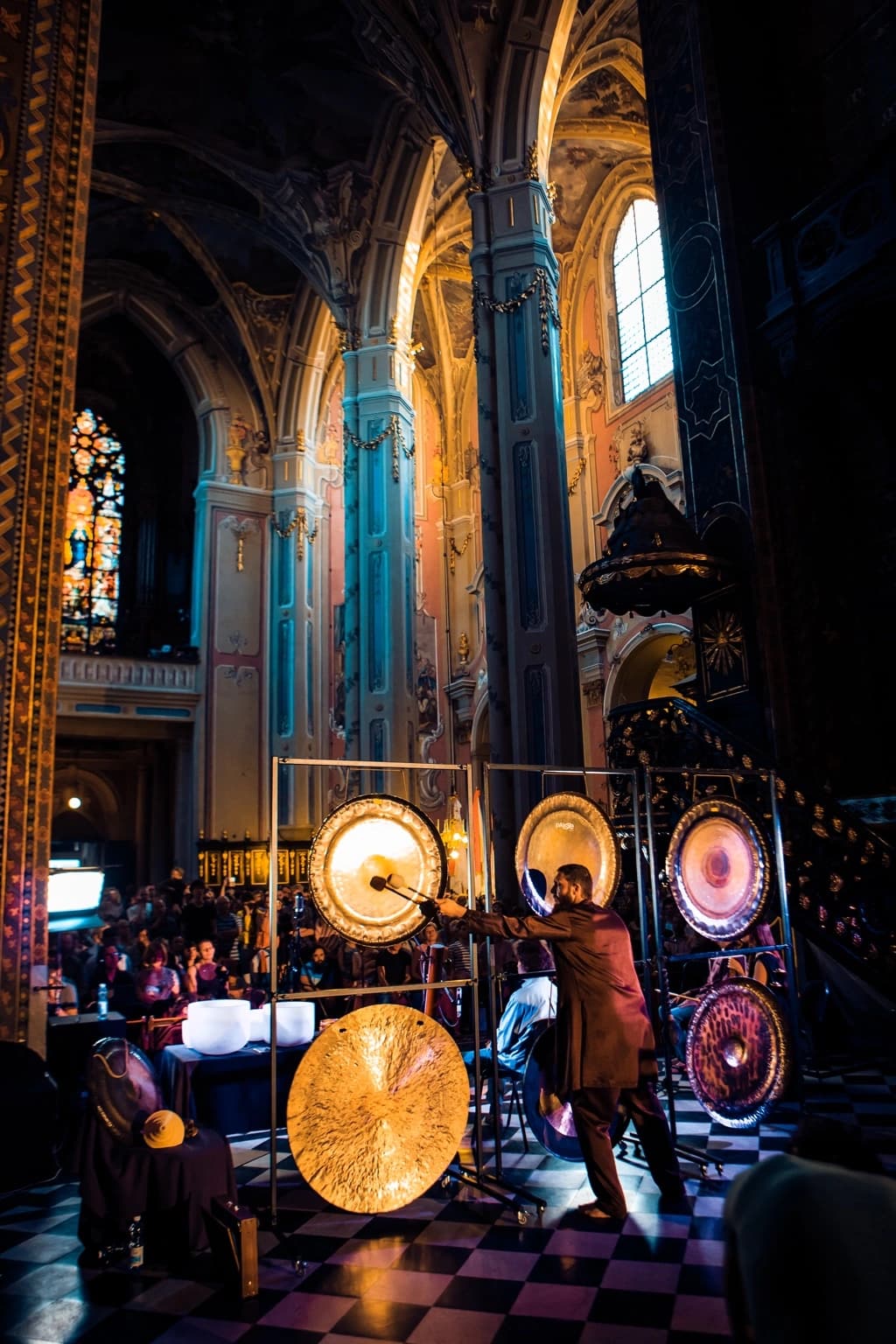 Gong master striking a gong during the performance